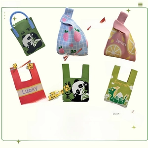 Close-up of various knit tote bags featuring strawberry, panda, and lemon fruit patterns