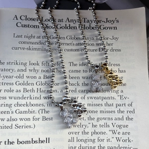 Close-up of bear pendants in gold and silver finishes with micro-inlaid zircon details