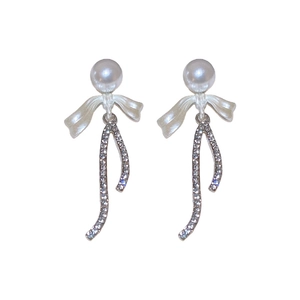 Elegant bow earrings with pearls and crystals featuring a stylish silver S-curve pendant