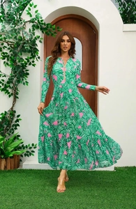 Detail of green tropical leaf print dress with long sleeves and gold front zipper