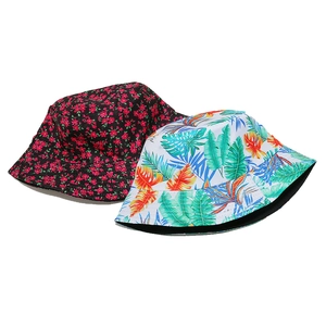 Detail of floral and tropical leaf prints on canvas bucket hats with reversible black lining