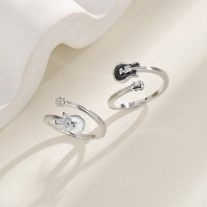 Minimalist guitar-shaped open rings in black and white enamel with small diamond accents