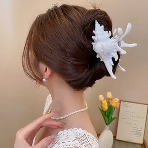 Elegant large white conch-shaped acrylic claw clip for French updo hairstyles