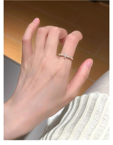 Detailed view of s925 silver ring featuring pearl band and rhinestone cross design