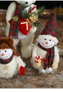 Detail of plush Christmas snowman and bear figurines with festive plaid scarves