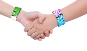Close-up of color-changing mermaid sequin slap bracelets in green and pink on wrists