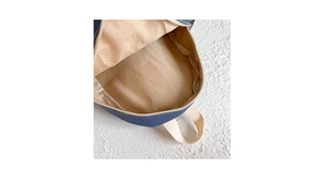 Detail of navy canvas backpack interior with beige fabric lining and zipper opening