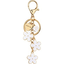Detail of gold keychain with white flowers, heart charm and LOVE YOU engraving