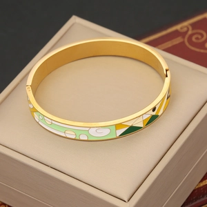 Detailed macro shot of vintage gold-plated enamel bracelet with abstract eye pattern