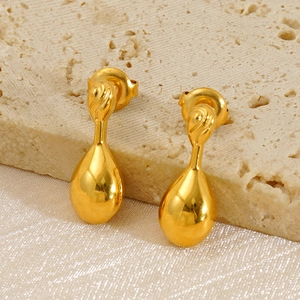 Polished minimalist gold teardrop earrings displayed on elegant silk and stone