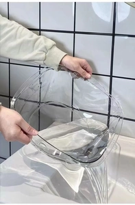 Close-up of clear plastic basin featuring wide anti-slip handles for easy carrying