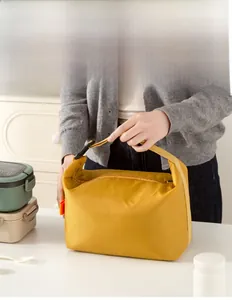 Detail view of reinforced buckle handle on the yellow insulated lunch bag for commuting