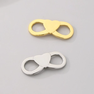 Detailed view of infinity heart jewelry charms in polished gold and silver finishes