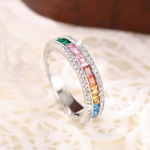 Detailed macro view of silver ring with rainbow zircon stones and white diamond accents