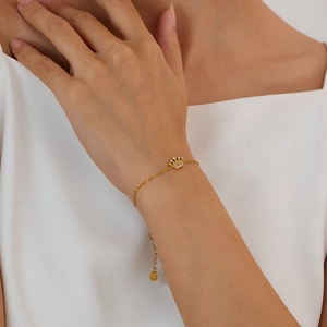 Detail of gold crown bracelet with small diamonds on wrist, minimalist french ins design