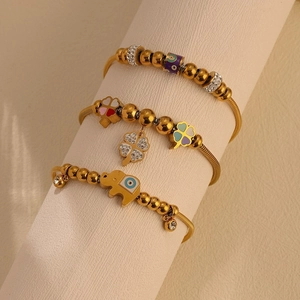 Bohemian gold bracelets with enamel clover, beaded charms and evil eye elephant pendant