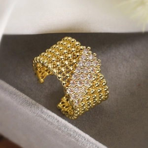 Detail of 18K gold-plated wide band ring with zircon stones in a velvet gift box