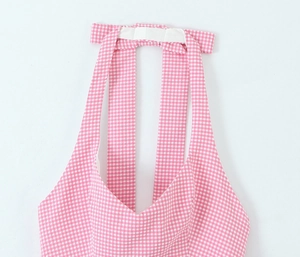 Close-up of pink and white gingham halter neck top with textured fabric detail
