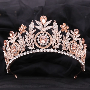 Close-up of rose gold bridal crown with champagne crystals and intricate leaf patterns