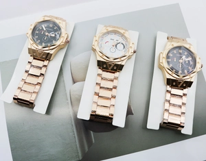 Detailed view of rose gold quartz watches with octagonal bezels and H-link steel straps