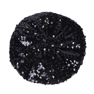 Top view of a black sequin beret showing circular shimmering details and glossy texture