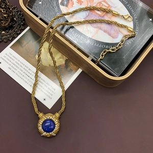 Detailed shot of lapis lazuli gold necklace on vintage wooden box and antique books