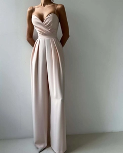 Detail of elegant V-neck satin jumpsuit featuring high waist and wide leg silhouette