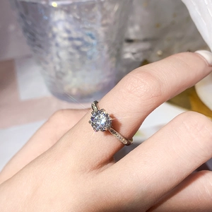 Sparkling silver V-shape open ring with round clear zircon stones on a model finger