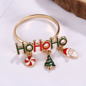 Detail of Christmas napkin ring featuring HOHOHO letters and holiday charms on white fabric