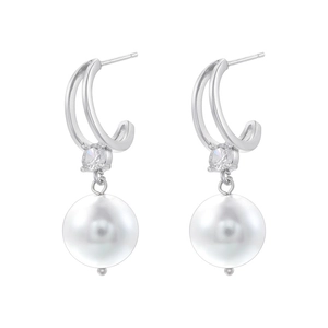 Detail of silver drop earrings featuring large white pearls and sparkling zircon accents
