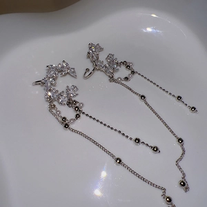 Elegant zircon crescent ear cuffs with pearl tassels and silver finish on white tray