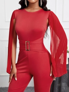 Elegant red jumpsuit featuring unique pleated cape sleeves and a gold waist buckle detail