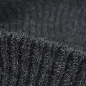 Close-up of charcoal grey wool blend knit hat featuring thick ribbed texture and soft fibers