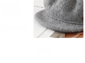 Detailed view of the structured grey wool cap brim with premium texture and stitching