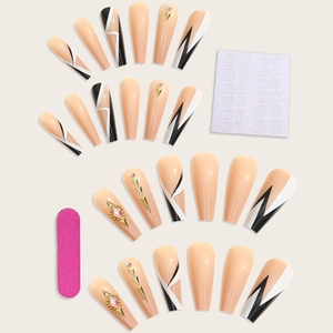 Detailed view of nude press-on nail kit with geometric patterns, rhinestones, and tools