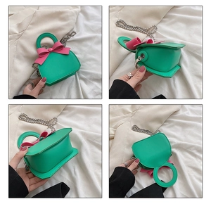 Four-angle view of mini green handbag with pink bow and silver beaded chain