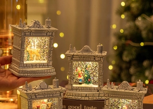 Detailed view of white crackle finish fireplace snow globe lanterns with warm LED lighting
