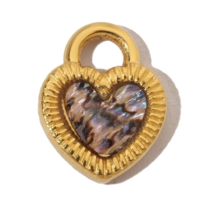 Close-up of heart-shaped gold pendant with iridescent shell inlay and smooth metallic edges