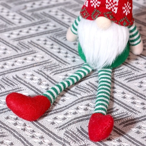 Close-up of long-legged Christmas gnome featuring a knitted snowflake hat and soft faux fur