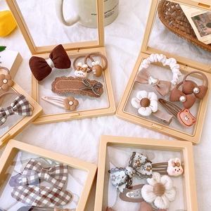 Set of 5 fabric hair accessories in brown tones presented in a clear gift box