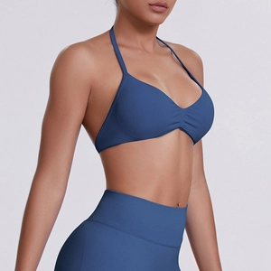 Side view of seamless dark blue halter neck sports bra and high waist fitness leggings