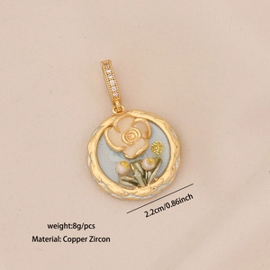 Macro detail of French vintage gold floral pendant with white zircon inlays and beige enamel