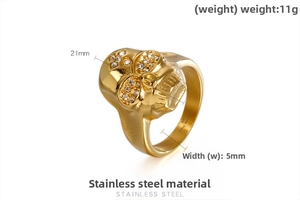 Detail of a gold skull ring in stainless steel with crystal eyes and 21mm face