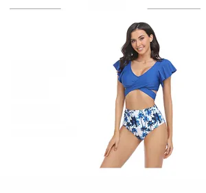 Detail of blue ruffled bikini top and high-waisted palm tree print swim bottoms
