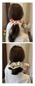 Detail showing a plaid scrunchie with white lace trim and a cute bear pattern ornament