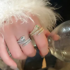Gold and silver snake-shaped wrap rings with sparkling cubic zirconia on model hand