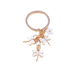 Creative keychain featuring three white enamel dragonflies and a flower on a gold ring