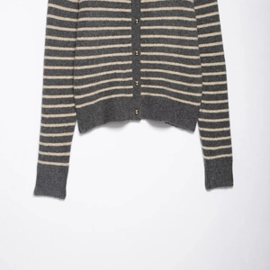 Short striped knit cardigan with gold buttons in dark grey and cream white texture