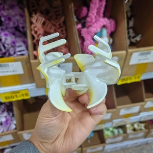 Close-up of a gradient plumeria hair claw clip with a strong metal spring mechanism