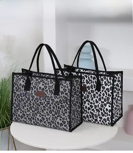 Detail view of large capacity leopard print tote bags in grey and white color variants